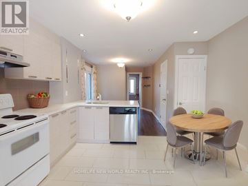 Toronto (Woodbine Corridor) apartment for rent - A kitchen with white appliances and a dining table with grey chairs.