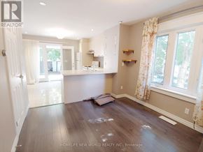 Toronto (Woodbine Corridor) apartment for rent - A room with wooden floors and white walls, with a window on the right side.