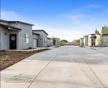 Visalia apartment for rent - A row of houses with a clear blue sky above them.