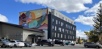 Steamboat Springs apartment for rent - A large mural on a building with cars parked in front.