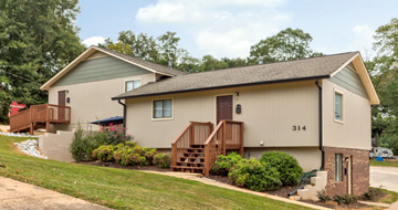 Gainesville apartment for rent - A house numbered 314 with a brown door and a brown staircase.