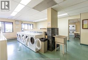 Windsor condo for rent - A laundry room with a washer and dryer stacked on top of each other.