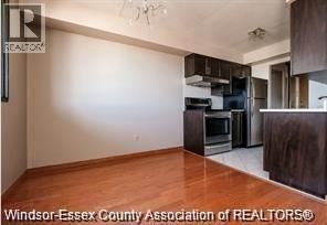 Windsor condo for rent - A kitchen with wooden floors and stainless steel appliances.
