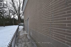 Toronto (Willowdale West) apartment for rent - A brick building with a sign that says "First Class Realty Inc., Brokerage.".
