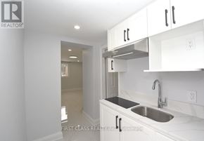 Toronto (Willowdale West) apartment for rent - A kitchen with white cabinets and a stainless steel sink.