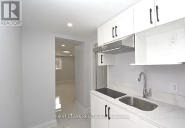 Toronto (Willowdale West) apartment for rent - A kitchen with white cabinets and a stainless steel sink.