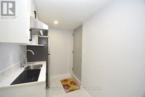 Toronto (Willowdale West) apartment for rent - A small kitchen with a sink and a refrigerator.