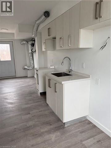 Welland townhouse for rent - A kitchen with white cabinets and a sink.