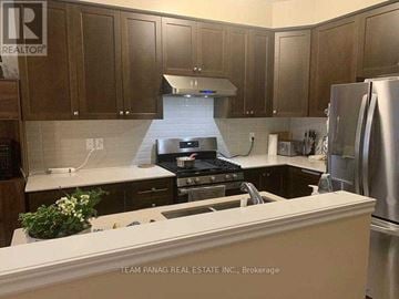 Brampton (Northwest Brampton) townhouse for rent - A kitchen with brown cabinets and a white countertop.