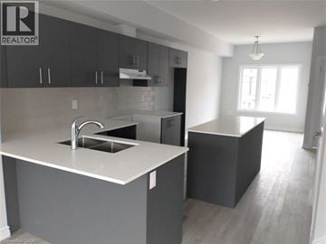 Cambridge townhouse for rent - A modern kitchen with a sink and cabinets.
