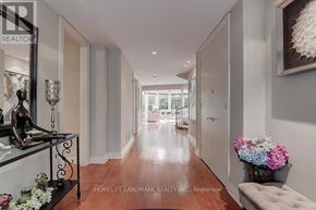 Toronto (Forest Hill South) apartment for rent - A hallway with a bench and a vase of flowers.