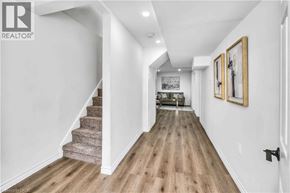 Waterloo apartment for rent - A hallway with a staircase and a couch in the background.