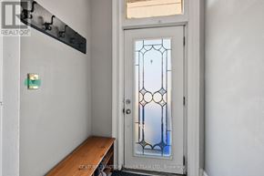 Ottawa apartment for rent - A door with a glass panel and a wooden bench in front of it.