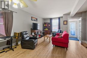 Ottawa apartment for rent - A living room with a red chair and a black leather chair.
