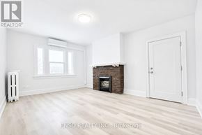 Niagara Falls (Cherrywood) multi-family for rent - A white room with a fireplace and a window.