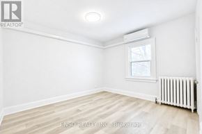 Niagara Falls (Cherrywood) multi-family for rent - A white room with a window and a radiator on the floor.