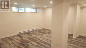 Toronto (Mount Dennis) townhouse for rent - A room with a carpeted floor and a window.