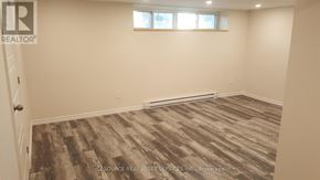 Toronto (Mount Dennis) townhouse for rent - A room with a wooden floor and a window.