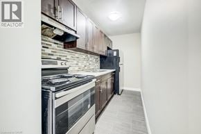 Waterloo apartment for rent - A modern kitchen with a stove top oven and a refrigerator.