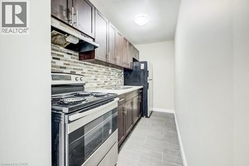 Waterloo apartment for rent - A modern kitchen with a stove top oven and a refrigerator.