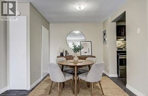 Waterloo apartment for rent - A dining room with a round mirror and a table with four chairs.
