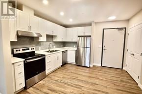 Dutton/Dunwich (Dutton) house for rent - A kitchen with white cabinets and a wooden floor.