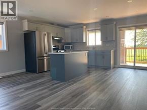 Lakeshore apartment for rent - A kitchen with a refrigerator, microwave, and oven.