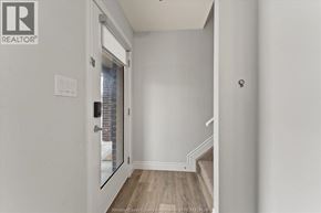 Lakeshore apartment for rent - A kitchen with white cabinets and a black fridge.