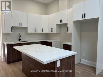 Fort Erie (Central) apartment for rent - A kitchen with white cabinets and a white countertop.
