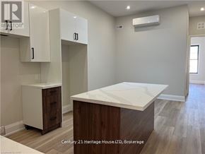 Fort Erie (Central) apartment for rent - A kitchen area with a white countertop and wooden cabinets.
