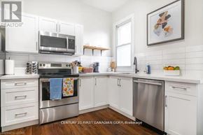 London South (South L) apartment for rent - A kitchen with white cabinets and a stainless steel oven.