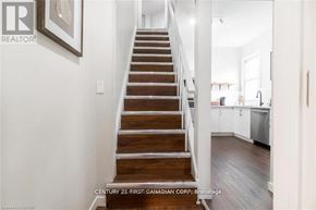 London South (South L) apartment for rent - A staircase in a house with a white wall and a painting on it.
