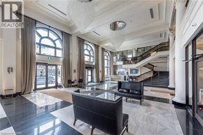 Hamilton condo for rent - A spacious lobby with a staircase and a large window.