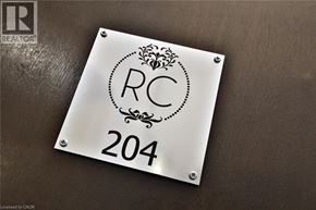 Hamilton condo for rent - A metal plate with the letters RC and the number 204 on it.