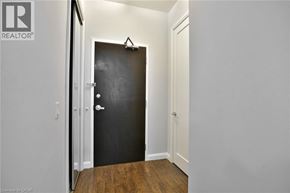 Hamilton condo for rent - A black door is in a white room.