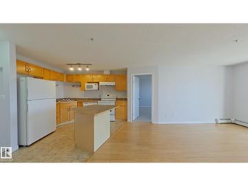 Edmonton apartment for rent - A kitchen with wooden cabinets and a white refrigerator.