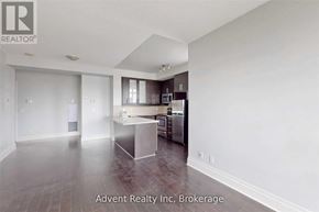 Markham (Unionville) condo for rent - A spacious kitchen with dark wood floors and white walls.