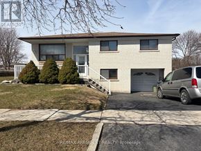 Mississauga (Malton) apartment for rent - A house with a car parked in front of it.
