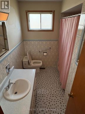 Mississauga (Malton) apartment for rent - A bathroom with a pink shower curtain and a white sink.