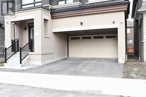 Pickering apartment for rent - A garage door is open in a brick house.