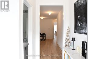 Pickering apartment for rent - A hallway with a Christmas tree and a painting on the wall.