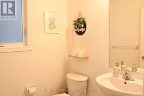 Pickering apartment for rent - A bathroom with a toilet, sink, and a welcome sign.