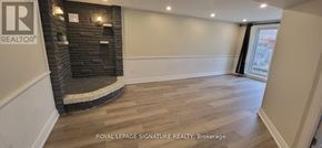 Kitchener apartment for rent - A room with a fireplace and wooden flooring.