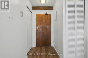 Ottawa multi-family for rent - A hallway with a wooden door and white walls.