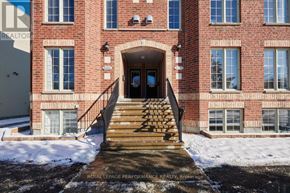 Ottawa townhouse for rent - A red brick building with a black door and windows.