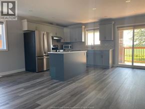 Lakeshore apartment for rent - A kitchen with a refrigerator, microwave, and oven.