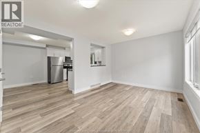 Lakeshore apartment for rent - A room with a vacuum cleaner on the wooden floor.