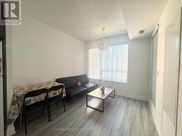 Markham (Unionville) condo for rent - A living room with a black couch and a wooden coffee table.