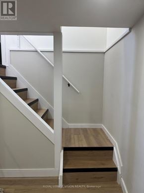 Niagara Falls (Church's Lane) apartment for rent - A staircase with a white railing and wooden steps.