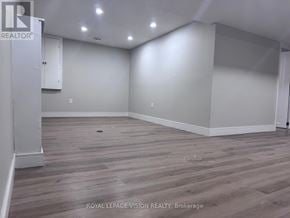 Niagara Falls (Church's Lane) apartment for rent - A spacious room with wooden flooring and white walls, likely for sale.